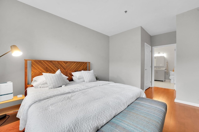 26 Ave At Port Imperial Unit 133, West New York, NJ 07093 - bedroom featuring wood finished floors and ensuite bath