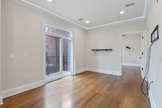 spare room featuring hardwood / wood-style floors, ornamental molding, and plenty of natural light