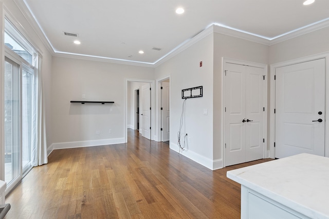 interior space featuring crown molding and wood-type flooring