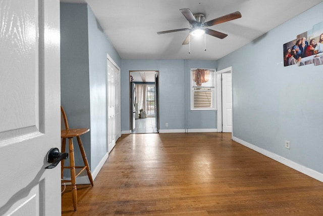 15 9th St, Bayonne, NJ 07002 - empty room with wood finished floors, baseboards, and a ceiling fan