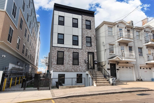 23 Westervelt Pl, Jersey City, NJ 07304 - view of front of property with a garage, stucco siding, fence, brick siding, and driveway