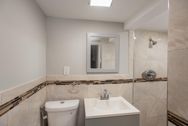 23 Westervelt Pl, Jersey City, NJ 07304 - bathroom featuring tile walls, toilet, vanity, wainscoting, and tiled shower