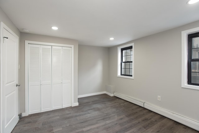 23 Westervelt Pl, Jersey City, NJ 07304 - unfurnished bedroom featuring a closet, recessed lighting, a baseboard heating unit, and dark wood finished floors