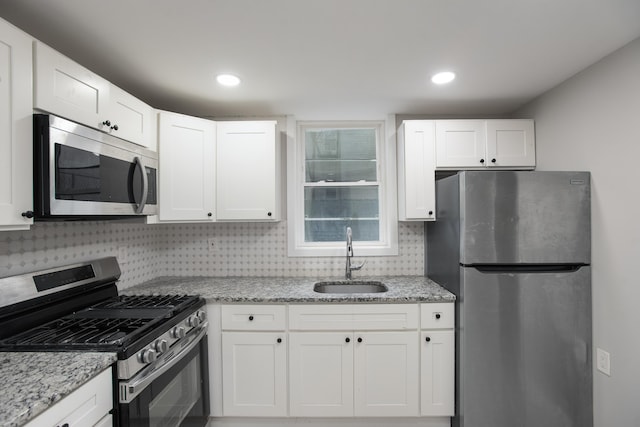 23 Westervelt Pl, Jersey City, NJ 07304 - kitchen with appliances with stainless steel finishes, a sink, and white cabinets
