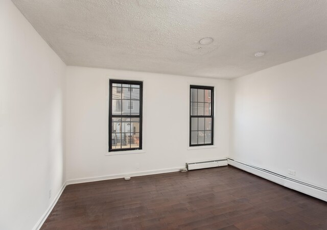 23 Westervelt Pl, Jersey City, NJ 07304 - empty room featuring dark wood-style flooring, baseboards, and a textured ceiling