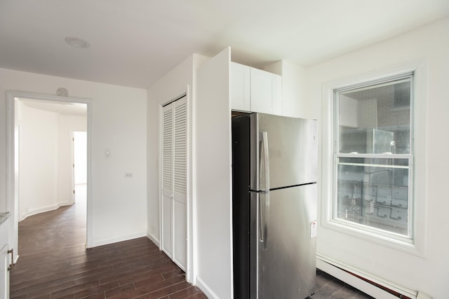 23 Westervelt Pl, Jersey City, NJ 07304 - kitchen with freestanding refrigerator, white cabinetry, dark wood-style flooring, a baseboard radiator, and baseboards