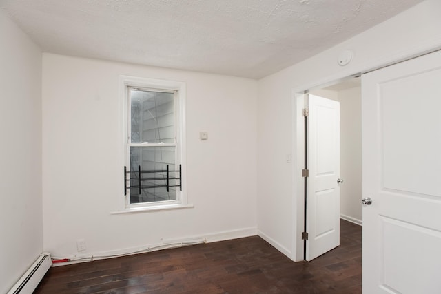 23 Westervelt Pl, Jersey City, NJ 07304 - empty room featuring dark wood-type flooring, a baseboard radiator, baseboards, and a textured ceiling