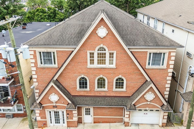 301 68th St Unit 8, Guttenberg, NJ 07093 - view of front of home featuring roof with shingles, brick siding, and a garage