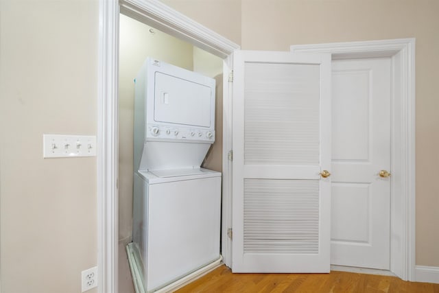 301 68th St Unit 8, Guttenberg, NJ 07093 - laundry area featuring stacked washer / dryer and light wood-style flooring