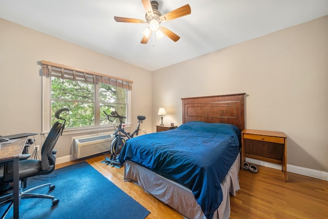 301 68th St Unit 8, Guttenberg, NJ 07093 - bedroom with a wall unit AC, a desk, light wood-type flooring, and ceiling fan