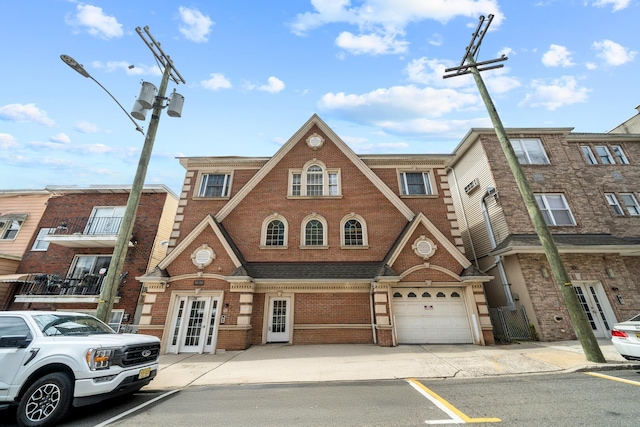 301 68th St Unit 8, Guttenberg, NJ 07093 - view of property with french doors, brick siding, a garage, and driveway