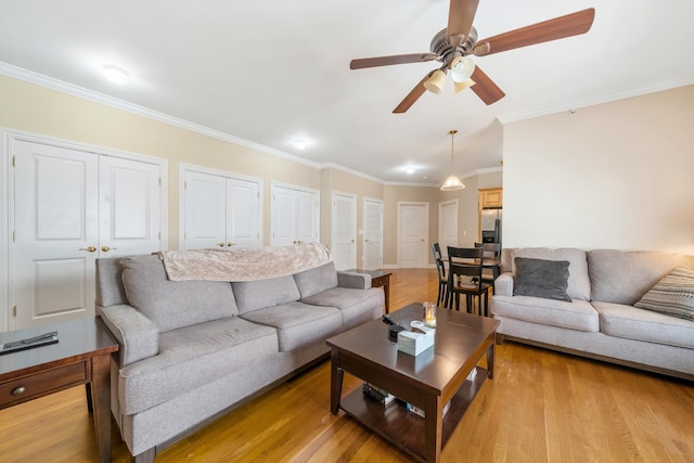 301 68th St Unit 8, Guttenberg, NJ 07093 - living room featuring crown molding, ceiling fan, and light wood-type flooring