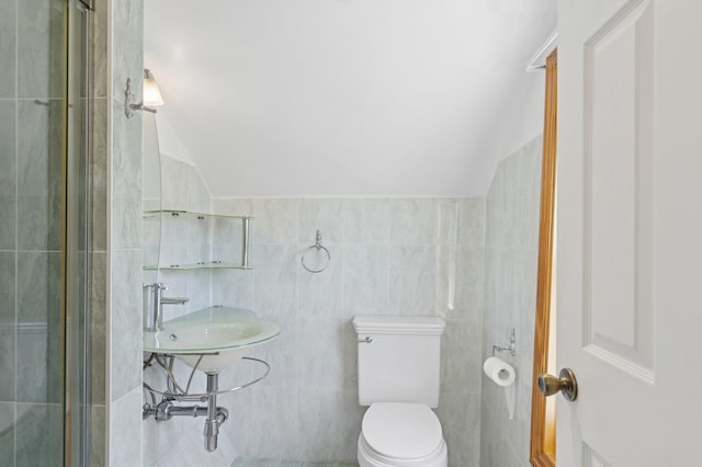16 Hazel Ave, Livingston, NJ 07039 - bathroom with tile walls, vaulted ceiling, toilet, and a sink