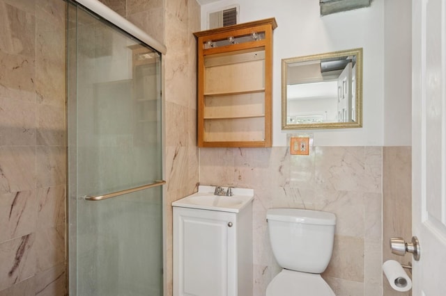 16 Hazel Ave, Livingston, NJ 07039 - bathroom featuring vanity, toilet, tile walls, and a stall shower