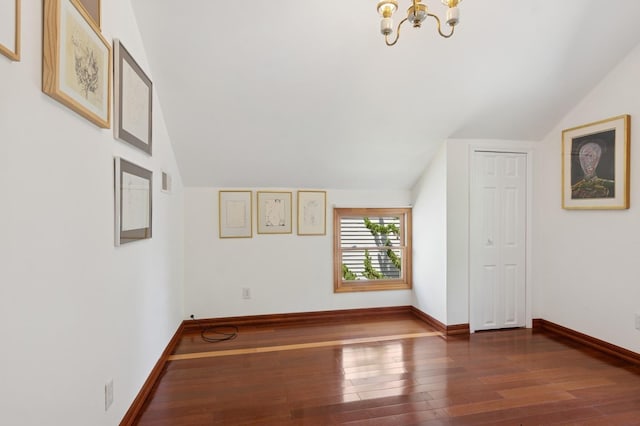 16 Hazel Ave, Livingston, NJ 07039 - unfurnished living room featuring a chandelier, lofted ceiling, hardwood / wood-style floors, and baseboards