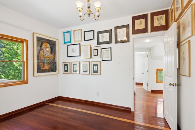 16 Hazel Ave, Livingston, NJ 07039 - empty room with a chandelier, dark wood-style floors, and baseboards