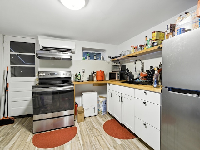 75 Reservoir Ave, Jersey City, NJ 07307 - kitchen featuring stainless steel appliances, open shelves, light wood finished floors, and an AC wall unit