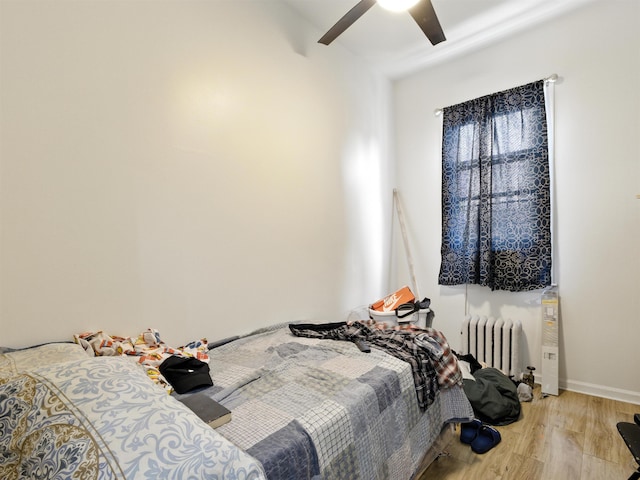 75 Reservoir Ave, Jersey City, NJ 07307 - bedroom featuring radiator, wood finished floors, and a ceiling fan