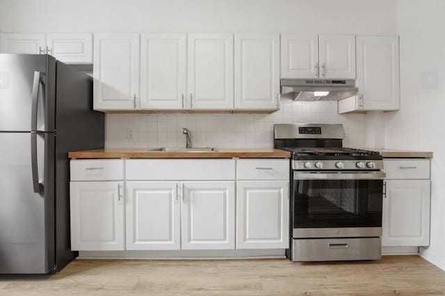 75 Reservoir Ave, Jersey City, NJ 07307 - kitchen featuring appliances with stainless steel finishes, under cabinet range hood, white cabinetry, and tasteful backsplash