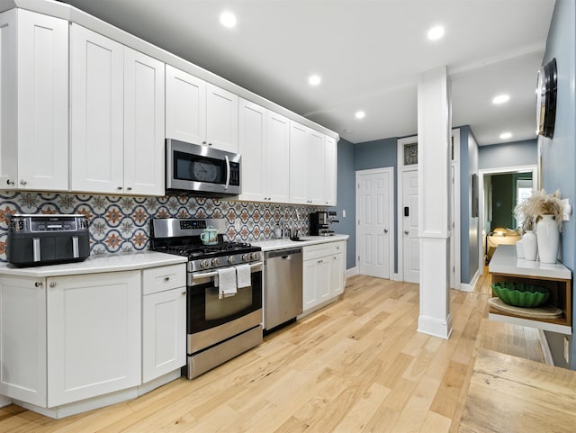 75 Reservoir Ave, Jersey City, NJ 07307 - kitchen with stainless steel appliances, light countertops, decorative backsplash, light wood finished floors, and recessed lighting
