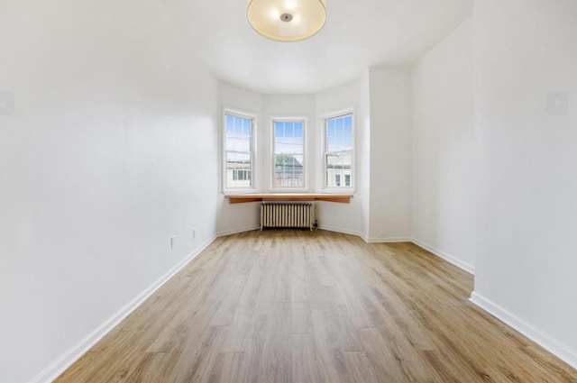 75 Reservoir Ave, Jersey City, NJ 07307 - spare room featuring radiator and wood finished floors