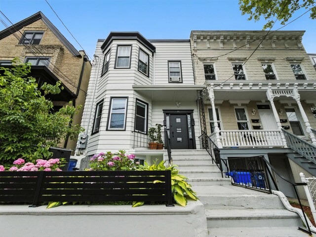 75 Reservoir Ave, Jersey City, NJ 07307 - view of front facade with covered porch and stairway