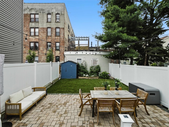 75 Reservoir Ave, Jersey City, NJ 07307 - fenced backyard featuring a storage unit, a patio area, an outdoor living space, and outdoor dining space