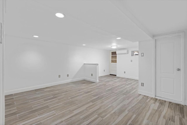 75 Reservoir Ave, Jersey City, NJ 07307 - finished basement with light wood finished floors, an AC wall unit, and recessed lighting