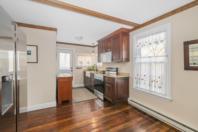 kitchen with sink, hanging light fixtures, electric range, dark hardwood / wood-style floors, and a baseboard radiator