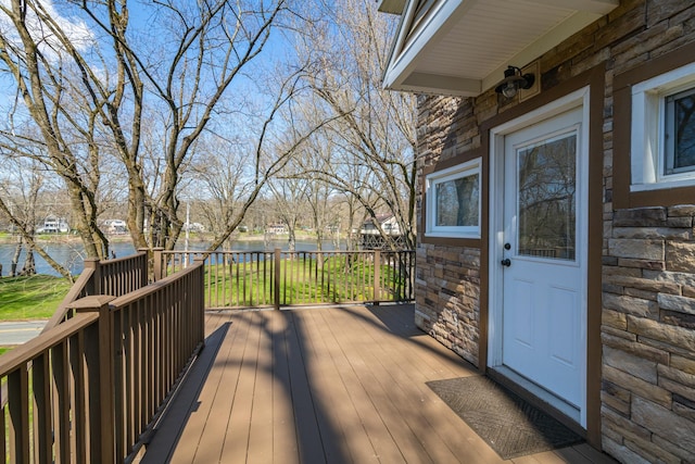 wooden deck featuring a water view