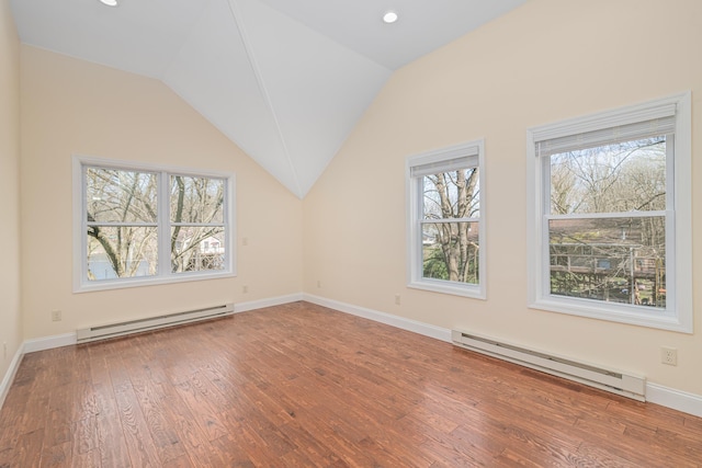 additional living space with wood-type flooring, a baseboard radiator, and vaulted ceiling