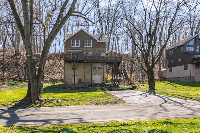 front facade with a garage and a front lawn