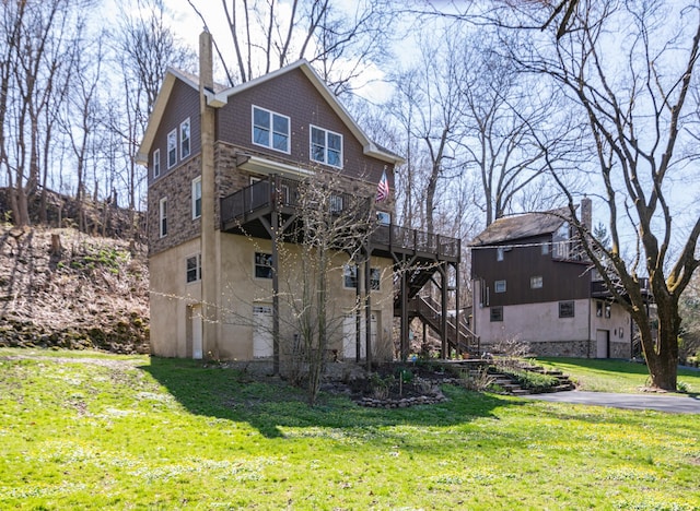 rear view of house featuring a yard