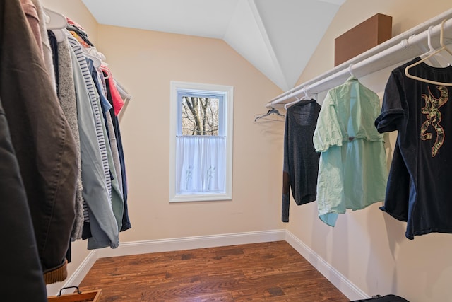 spacious closet featuring dark wood-type flooring and vaulted ceiling