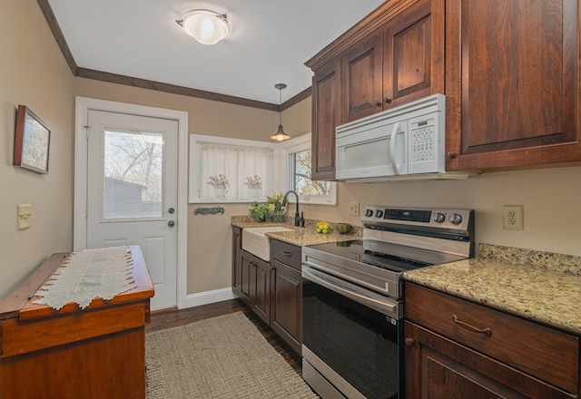 kitchen featuring light stone countertops, sink, hanging light fixtures, and stainless steel electric range