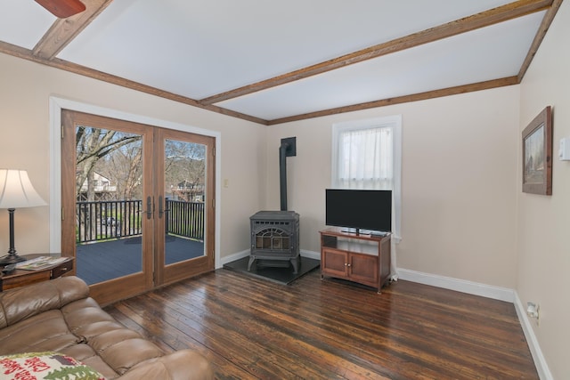 living room with a wood stove, ceiling fan, french doors, beamed ceiling, and dark hardwood / wood-style floors