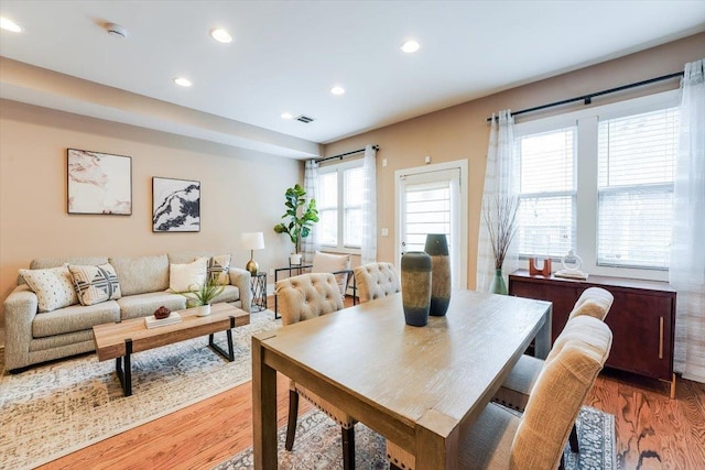 dining space with light wood-style floors, recessed lighting, and visible vents