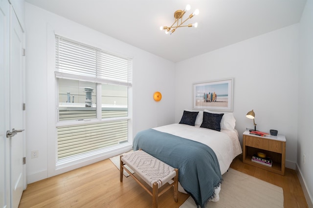 414 1st St Unit 5, Jersey City, NJ 07302 - bedroom with a chandelier and wood finished floors