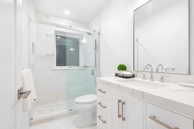 bathroom featuring toilet, an enclosed shower, vanity, and tile patterned flooring