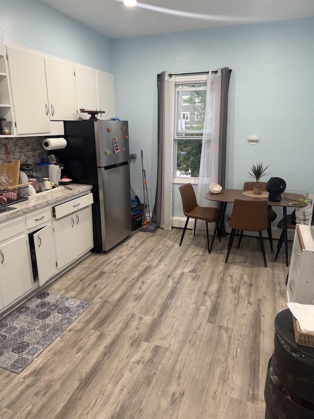 4312 Cottage St, North Bergen, NJ 07047 - kitchen featuring light countertops, open shelves, light wood-type flooring, and decorative backsplash