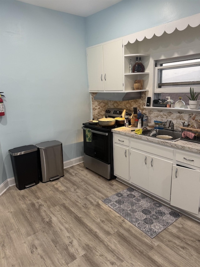 4312 Cottage St, North Bergen, NJ 07047 - kitchen featuring electric range, backsplash, light wood-style flooring, open shelves, and white cabinets