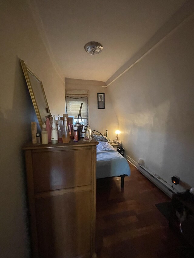 33 Clerk St, Jersey City, NJ 07305 - bedroom with wood finished floors, a baseboard radiator, and baseboards