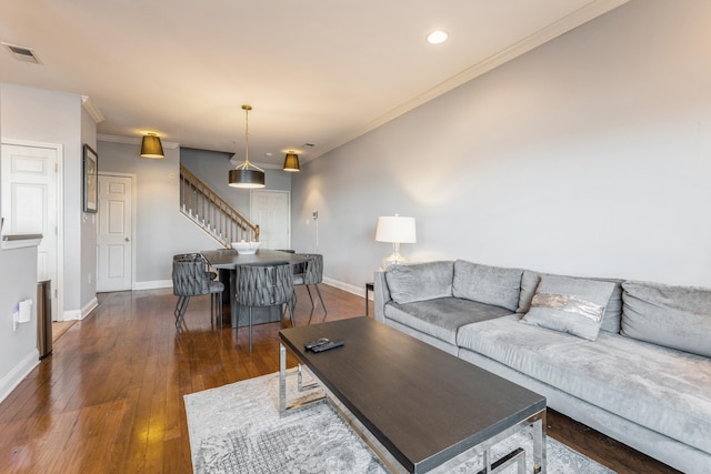 living room with ornamental molding and dark wood-type flooring