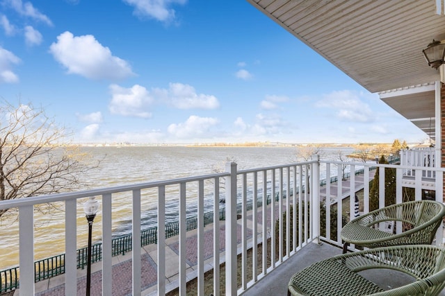 balcony featuring a water view and a view of the beach