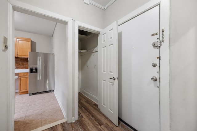 interior space featuring baseboards and wood finished floors