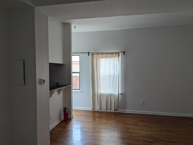 empty room with dark hardwood / wood-style floors