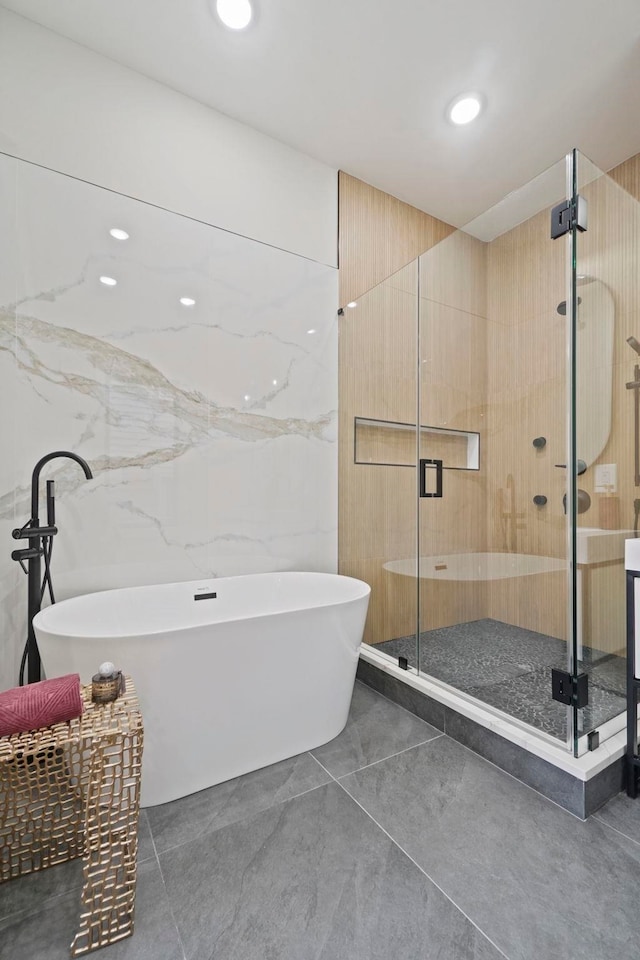 bathroom featuring shower with separate bathtub