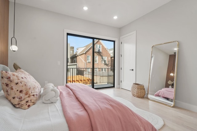 bedroom with light hardwood / wood-style floors and access to outside