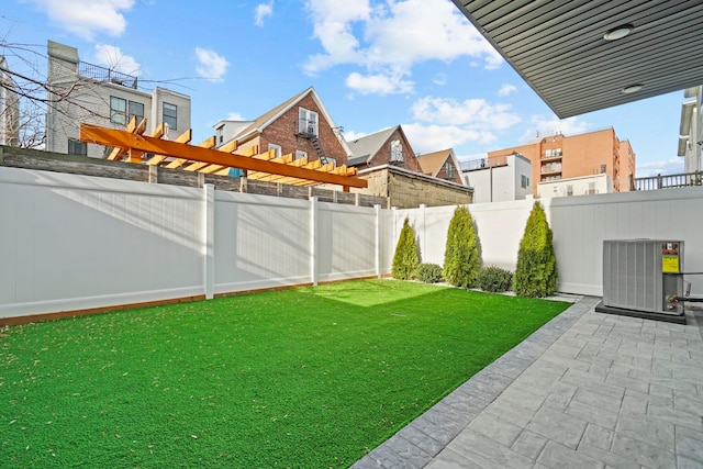 view of yard with cooling unit, a pergola, and a patio