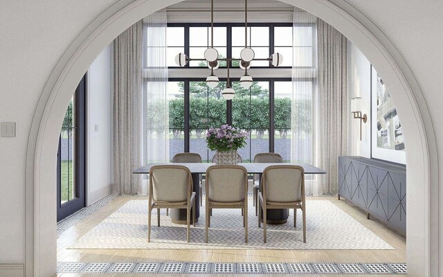 dining area with arched walkways and baseboards